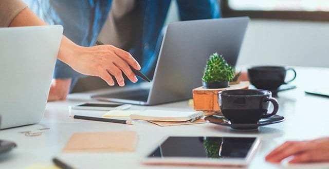 Group of businessman discussing and working on laptop computer on the table in office